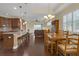 Bright dining room featuring dark hardwood floors, plantation shutters and decorative chandelier at 2419 Richmond Greens Ct, Sun City Center, FL 33573