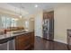 Updated kitchen featuring stainless steel appliances, granite counters, and a breakfast bar at 2419 Richmond Greens Ct, Sun City Center, FL 33573