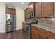 Modern kitchen with stainless steel appliances, granite countertops, and stylish backsplash at 2419 Richmond Greens Ct, Sun City Center, FL 33573