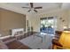 Inviting living room boasting tray ceiling, ceiling fan, and sliding glass doors at 2419 Richmond Greens Ct, Sun City Center, FL 33573