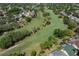 An aerial view of a beautiful golf course with lush greenery and attractive homes nearby at 2925 Starmount Dr, Valrico, FL 33596