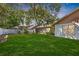 Expansive backyard features lush lawn, a white privacy fence, and mature trees offering ample shade at 2925 Starmount Dr, Valrico, FL 33596