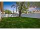 Large backyard featuring a well-maintained lawn, privacy fence, and mature trees, perfect for outdoor activities at 2925 Starmount Dr, Valrico, FL 33596