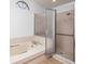 Bathroom featuring shower and tub combination with natural light from window at 2925 Starmount Dr, Valrico, FL 33596