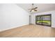 Bedroom featuring wood floors, a ceiling fan, and sliding glass doors leading to the backyard at 2925 Starmount Dr, Valrico, FL 33596
