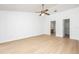 Large bedroom featuring wood floors, a ceiling fan, and access to the bathroom and walk-in closet at 2925 Starmount Dr, Valrico, FL 33596