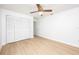 Bright bedroom featuring wood laminate flooring and closet at 2925 Starmount Dr, Valrico, FL 33596