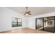 Sunlit bedroom featuring a ceiling fan and sliding glass door to the screened lanai at 2925 Starmount Dr, Valrico, FL 33596