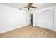 Spacious bedroom featuring white walls, hardwood floors, a ceiling fan, and a closet at 2925 Starmount Dr, Valrico, FL 33596