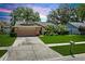 Inviting single-story home with a well-kept lawn, two-car garage, and verdant landscaping at 2925 Starmount Dr, Valrico, FL 33596