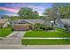Lovely single-story home boasts a manicured lawn, two-car garage, and mature trees and shrubbery at 2925 Starmount Dr, Valrico, FL 33596