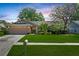 Charming single-story home with a well-manicured lawn and a two-car garage, complemented by lush landscaping at 2925 Starmount Dr, Valrico, FL 33596