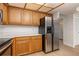 Kitchen featuring wood cabinets, stainless steel appliances, and light countertops at 2925 Starmount Dr, Valrico, FL 33596