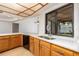 Kitchen with white countertops, wooden cabinets, and a view of the backyard through the window at 2925 Starmount Dr, Valrico, FL 33596
