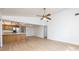 Bright, open-concept living room with kitchen, hardwood floors and ceiling fan at 2925 Starmount Dr, Valrico, FL 33596