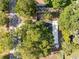 An aerial view of the property surrounded by mature trees and landscaping at 303 National Orange Ave, Oldsmar, FL 34677