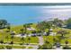 An aerial view of a park with lush green space, gazebos, and waterfront access at 303 National Orange Ave, Oldsmar, FL 34677