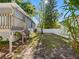 Spacious backyard area surrounded by a white fence and mature landscaping at 303 National Orange Ave, Oldsmar, FL 34677