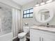 Bright bathroom with granite vanity and shower-tub combination at 303 National Orange Ave, Oldsmar, FL 34677