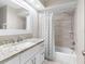 Bright bathroom with a granite vanity, white cabinets, and shower-tub combination at 303 National Orange Ave, Oldsmar, FL 34677