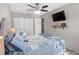 Bedroom featuring a ceiling fan, closet, television, and carpeted floor at 303 National Orange Ave, Oldsmar, FL 34677