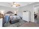 Serene bedroom with neutral tones, a ceiling fan, and calming natural light at 303 National Orange Ave, Oldsmar, FL 34677