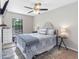 Bright bedroom featuring a ceiling fan, window, and carpeted floor at 303 National Orange Ave, Oldsmar, FL 34677