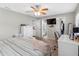 Bedroom featuring a ceiling fan, a television and an ensuite bathroom with vanity at 303 National Orange Ave, Oldsmar, FL 34677