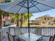 Outdoor deck featuring a patio set, perfect for enjoying outdoor meals with serene water views at 303 National Orange Ave, Oldsmar, FL 34677