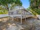 Rear deck offers outdoor enjoyment with a partial view of a screened-in patio, enhancing outdoor living at 303 National Orange Ave, Oldsmar, FL 34677