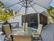 Outdoor deck features a dining set and water views, perfect for al fresco dining and outdoor enjoyment at 303 National Orange Ave, Oldsmar, FL 34677