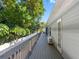 Wooden deck provides an outdoor space for relaxation and enjoying the surrounding greenery, featuring access to the house at 303 National Orange Ave, Oldsmar, FL 34677