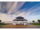 A gazebo on a brick surface overlooks the water under a brilliant sky with thin cirrus clouds at 303 National Orange Ave, Oldsmar, FL 34677