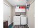 Laundry room with modern washer and dryer, plus storage cabinets at 303 National Orange Ave, Oldsmar, FL 34677