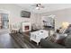 Inviting living room boasts a fireplace, stylish furnishings, and a ceiling fan at 303 National Orange Ave, Oldsmar, FL 34677
