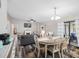 Open layout featuring the dining and living area with modern furnishings and natural light at 303 National Orange Ave, Oldsmar, FL 34677