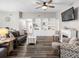 Bright living room featuring updated flooring, a fireplace, and ample seating at 303 National Orange Ave, Oldsmar, FL 34677