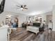 Open-concept living room with a cozy sectional couch and views of the kitchen and dining area at 303 National Orange Ave, Oldsmar, FL 34677