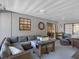 Inviting screened-in patio with comfortable seating and charming decor, ideal for relaxation and entertaining guests at 303 National Orange Ave, Oldsmar, FL 34677