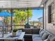 Cozy screened-in patio offers scenic water views, comfortable seating, and a perfect space for outdoor relaxation at 303 National Orange Ave, Oldsmar, FL 34677