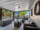 Relaxing screened-in patio with water view, furnished with a cozy seating area and a peaceful outdoor ambiance at 303 National Orange Ave, Oldsmar, FL 34677