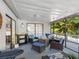 Charming screened patio with comfortable seating, creates an inviting outdoor space for relaxation and entertainment at 303 National Orange Ave, Oldsmar, FL 34677