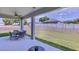 Covered patio with outdoor seating overlooking the spacious backyard and white vinyl fence at 3312 Amber Waves Dr, Plant City, FL 33565