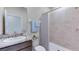 Bathroom features vanity with stone countertop, white tile shower and tub combination at 3318 Amber Waves Dr, Plant City, FL 33565