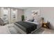 Well-lit bedroom showcases a tufted headboard, decorative artwork, and minimalist furnishings at 3318 Amber Waves Dr, Plant City, FL 33565