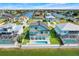 Stunning aerial view of a waterfront property with a pool, balconies, and lush green landscaping at 3496 Amberjack Dr, Hernando Beach, FL 34607
