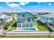 Beautiful house from an aerial view, showing off it's blue exterior, balconies, pool, and lush landscaping at 3496 Amberjack Dr, Hernando Beach, FL 34607