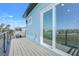 View of the balcony of a beautifully designed home with water views, featuring sleek railings and ample space at 3496 Amberjack Dr, Hernando Beach, FL 34607