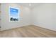 Bright bedroom with a double-hung window and light wood flooring at 3496 Amberjack Dr, Hernando Beach, FL 34607