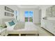 Serene bedroom featuring a tray ceiling and water views from the large sliding doors at 3496 Amberjack Dr, Hernando Beach, FL 34607
